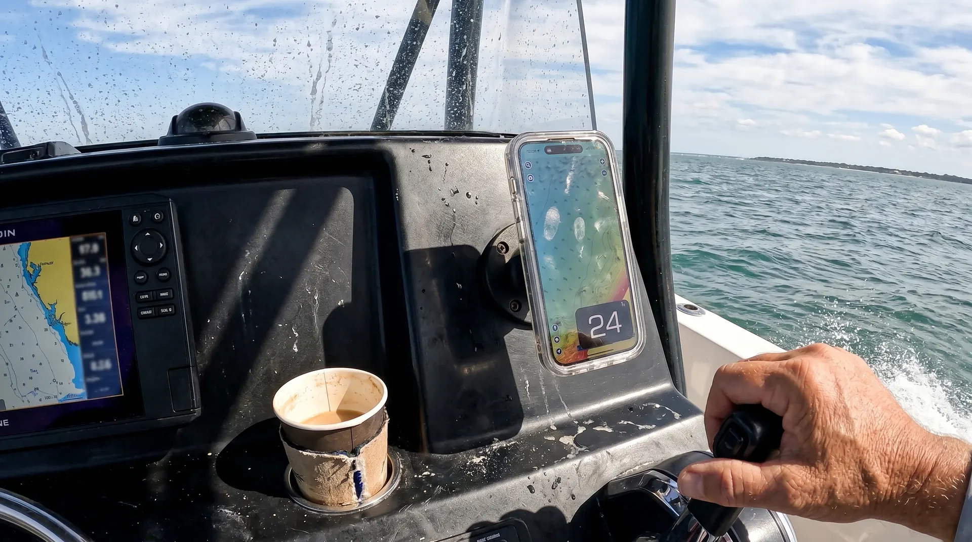 GPS Speedometer's Picture-in-Picture window floating over a marine chart on a powerboat console at sea